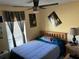 Bedroom featuring a comfortable bed, ceiling fan, and personalized decor at 1663 Sunburst Way, Kissimmee, FL 34744