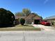 Charming single-story home featuring a well-maintained lawn and stone accents on the facade at 1663 Sunburst Way, Kissimmee, FL 34744