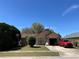 Quaint single-Gathering home with mature trees and front lawn, showcasing its curb appeal at 1663 Sunburst Way, Kissimmee, FL 34744