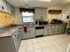 Traditional kitchen with granite countertops, tiled floors, and modern appliances at 1663 Sunburst Way, Kissimmee, FL 34744