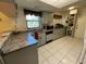 Traditional kitchen featuring light cabinets, granite countertops, and a garden view at 1663 Sunburst Way, Kissimmee, FL 34744