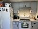 Bright kitchen with neutral cabinets, granite countertops and white appliances at 1663 Sunburst Way, Kissimmee, FL 34744
