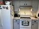 Cozy kitchen features white appliances, cabinets, and granite countertops at 1663 Sunburst Way, Kissimmee, FL 34744