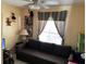 Cozy living room featuring a comfortable sofa and natural light from the window at 1663 Sunburst Way, Kissimmee, FL 34744