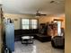 Comfortable living area with tile flooring and a cozy seating arrangement and fan at 1663 Sunburst Way, Kissimmee, FL 34744