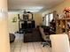 Open-concept living room featuring tile flooring, ceiling fan, and comfortable seating arrangement at 1663 Sunburst Way, Kissimmee, FL 34744
