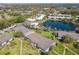 Aerial view of community with pool, pond, and parking at 1695 Lee Rd # E205, Winter Park, FL 32789