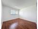 Bedroom with wood floors and natural light from a window at 1695 Lee Rd # E205, Winter Park, FL 32789