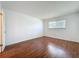 Bedroom featuring wood floors and natural light from a large window at 1695 Lee Rd # E205, Winter Park, FL 32789