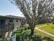 Multi-level condo building featuring balconies, green landscaping, and walking paths at 1695 Lee Rd # E205, Winter Park, FL 32789