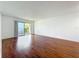 Spacious living room featuring sleek hardwood floors and a sliding glass door to the outside at 1695 Lee Rd # E205, Winter Park, FL 32789