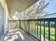 Wood patio with railings offers green space views and sunshine at 1695 Lee Rd # E205, Winter Park, FL 32789