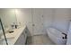 This bathroom boasts a soaking tub, double sink vanity, and modern fixtures, perfect for a relaxing retreat at 18410 Blue Heron Cir, Deer Island, FL 32778