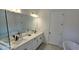 Bright bathroom features a double sink vanity, soaking tub, tiled floor and modern fixtures for a spa-like experience at 18410 Blue Heron Cir, Deer Island, FL 32778