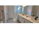 The bathroom features a double sink vanity, soaking tub, enclosed shower and modern fixtures for a luxurious experience at 18410 Blue Heron Cir, Deer Island, FL 32778