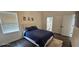 Bedroom with a bed, window and attached bathroom at 18410 Blue Heron Cir, Deer Island, FL 32778