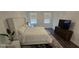 Comfortable bedroom with plush king bed, contemporary decor, and natural light offers a peaceful retreat at 18410 Blue Heron Cir, Deer Island, FL 32778