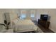 Comfortable bedroom with plush king bed, contemporary decor, and natural light offers a peaceful retreat at 18410 Blue Heron Cir, Deer Island, FL 32778