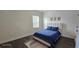 Comfortable bedroom with a plush blue bedspread and a modern rug at 18410 Blue Heron Cir, Deer Island, FL 32778