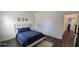 Comfortable bedroom with a plush blue bedspread and a modern rug at 18410 Blue Heron Cir, Deer Island, FL 32778