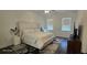 Comfortable bedroom with plush king bed, contemporary decor, and natural light offers a peaceful retreat at 18410 Blue Heron Cir, Deer Island, FL 32778