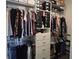 Well-organized closet with hanging clothes, shoe racks, and storage drawers at 18410 Blue Heron Cir, Deer Island, FL 32778