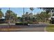 Well-maintained community entrance with beautiful landscaping at 18410 Blue Heron Cir, Deer Island, FL 32778