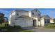 Elegant home featuring a stucco facade, gray shutters, a two-car garage, and an inviting front entrance at 18410 Blue Heron Cir, Deer Island, FL 32778
