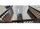 Entryway foyer with dark wood floors and black railings at 18410 Blue Heron Cir, Deer Island, FL 32778