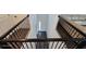 A view from the second story of the foyer featuring railing and a wood floor at 18410 Blue Heron Cir, Deer Island, FL 32778