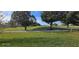 Expansive green golf course featuring mature trees at 18410 Blue Heron Cir, Deer Island, FL 32778