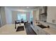 Modern kitchen featuring stainless steel appliances, white cabinets, and breakfast nook area at 18410 Blue Heron Cir, Deer Island, FL 32778