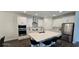 Bright kitchen features white cabinets, stainless steel appliances, and large center island with seating at 18410 Blue Heron Cir, Deer Island, FL 32778