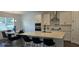 Eat-in kitchen with stainless appliances, white cabinets, stone countertops and island seating at 18410 Blue Heron Cir, Deer Island, FL 32778