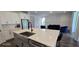 Kitchen island featuring white quartz countertop, stainless steel sink, and stainless steel appliances at 18410 Blue Heron Cir, Deer Island, FL 32778