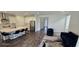 Modern kitchen features an island with seating, stainless steel appliances, and sleek white cabinetry at 18410 Blue Heron Cir, Deer Island, FL 32778