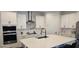 Bright kitchen features white cabinets, stainless steel appliances, and large center island with seating at 18410 Blue Heron Cir, Deer Island, FL 32778
