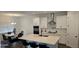 Open-concept kitchen with stainless steel appliances, center island, and adjacent dining area at 18410 Blue Heron Cir, Deer Island, FL 32778
