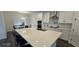 Open-concept kitchen with stainless steel appliances, center island, and adjacent dining area at 18410 Blue Heron Cir, Deer Island, FL 32778