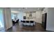 Bright kitchen with large island, stainless steel appliances, dark wood floors, and a dining area at 18410 Blue Heron Cir, Deer Island, FL 32778
