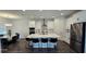 Bright, modern kitchen featuring a large center island, stainless steel appliances, and sleek white cabinetry at 18410 Blue Heron Cir, Deer Island, FL 32778