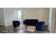 Bright living room featuring dark floors, a modern couch, chairs, and a sliding glass door at 18410 Blue Heron Cir, Deer Island, FL 32778