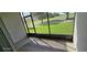 Enclosed outdoor patio area offering serene golf course views at 18410 Blue Heron Cir, Deer Island, FL 32778
