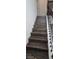Wooden staircase with black metal railing at 18410 Blue Heron Cir, Deer Island, FL 32778