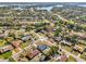 This aerial view shows the property's proximity to a lake and its location within a residential community at 2169 Webster Ct, Deltona, FL 32738