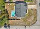 This aerial view showcases a home with a pool, fenced yard, and a driveway leading to a well-maintained neighborhood street at 2169 Webster Ct, Deltona, FL 32738