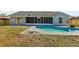 Backyard view showcases the sparkling pool and the house's exterior at 2169 Webster Ct, Deltona, FL 32738