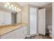 Bathroom featuring a granite countertop vanity, large mirror, shower, and linen closet at 2169 Webster Ct, Deltona, FL 32738