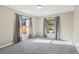 Carpeted bedroom with two windows overlooking the backyard pool area at 2169 Webster Ct, Deltona, FL 32738