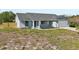 The exterior of the home is painted gray with a blue front door, complimented by a well-manicured lawn at 2169 Webster Ct, Deltona, FL 32738